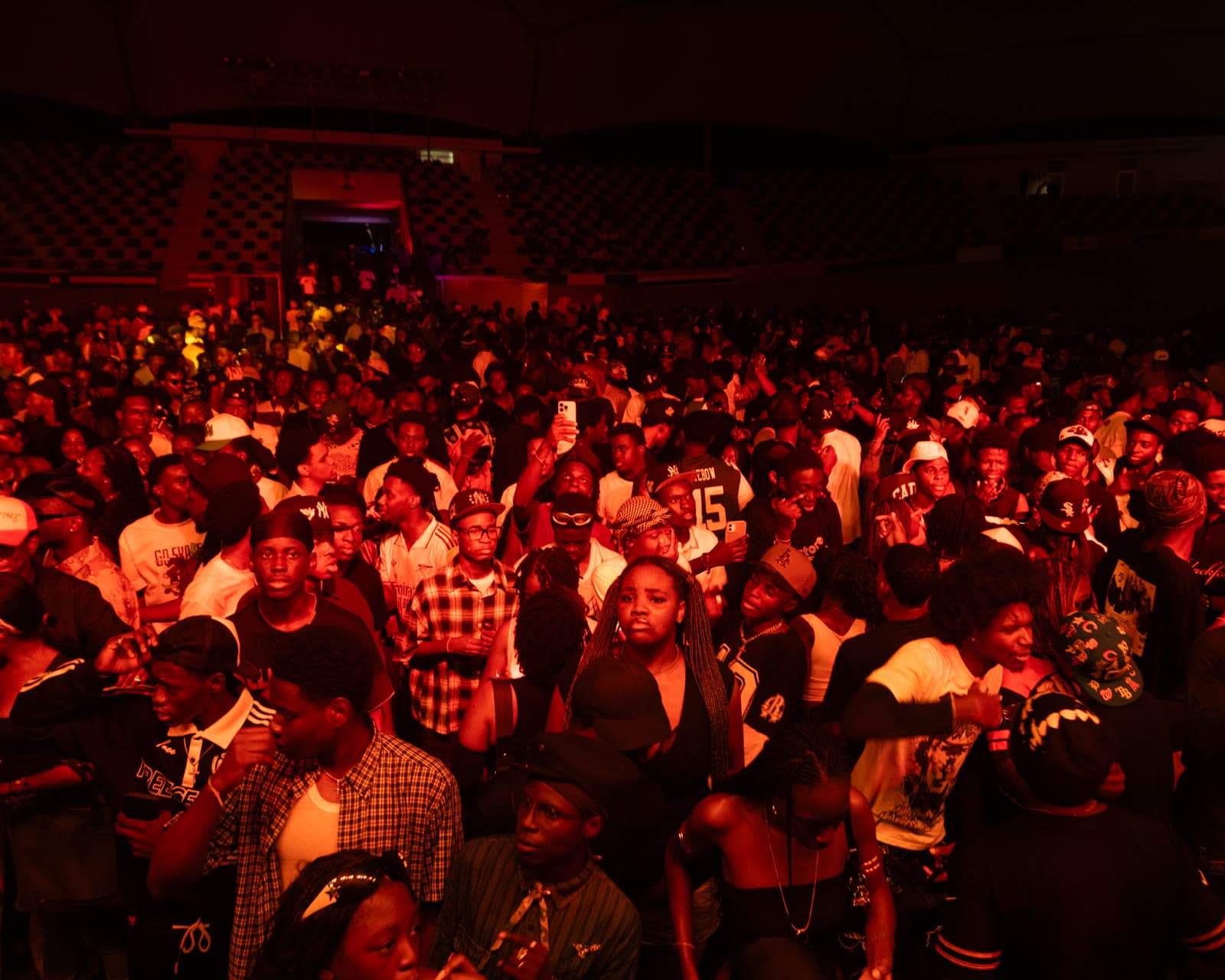 A packed Trance crowd under red lighting